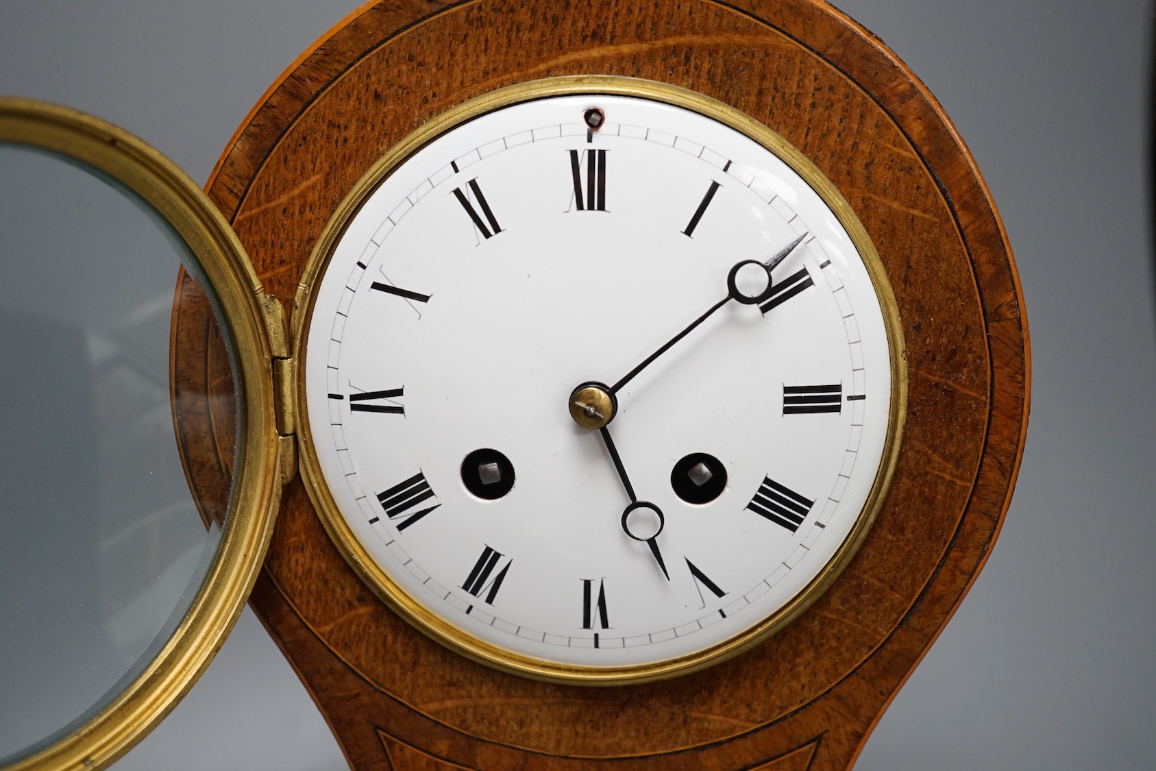 An Edwardian oak and marquetry balloon clock - 30cm tall